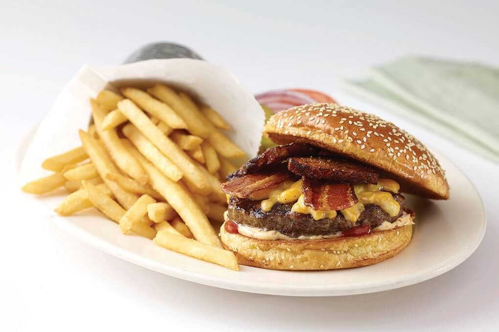 Bacon-Bacon Cheeseburger with melted cheddar, American cheese, crispy bacon, slow-roasted smoked bacon, secret sauce 