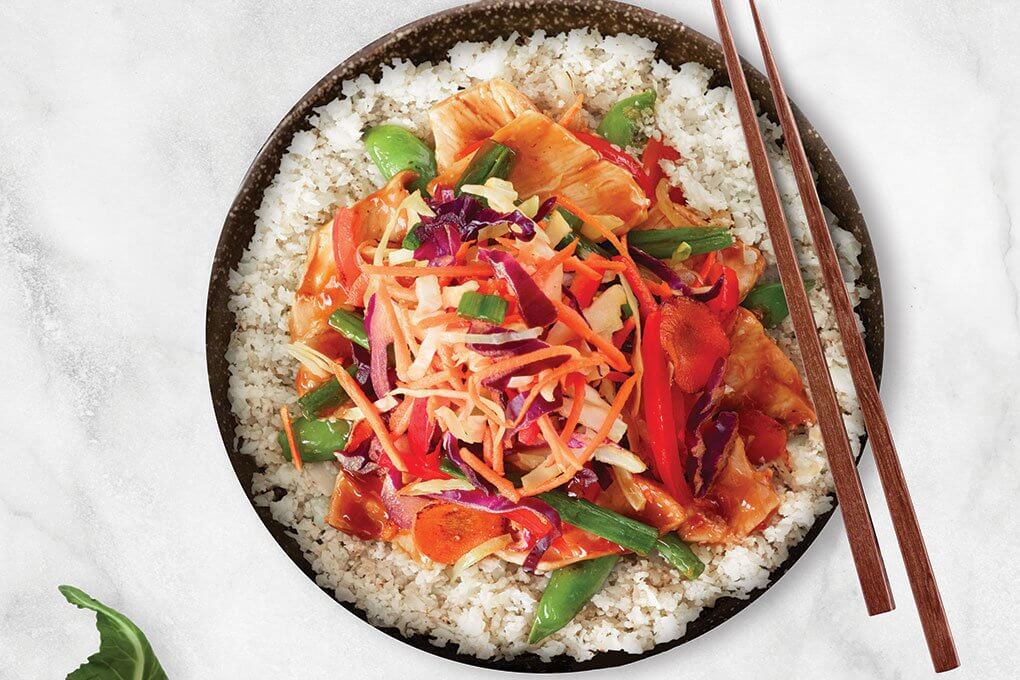 Cauliflower “rice,” chicken, carrots, bell peppers, snap peas, scallion, ginger, tamarind and chile-soy glaze, Asian slaw