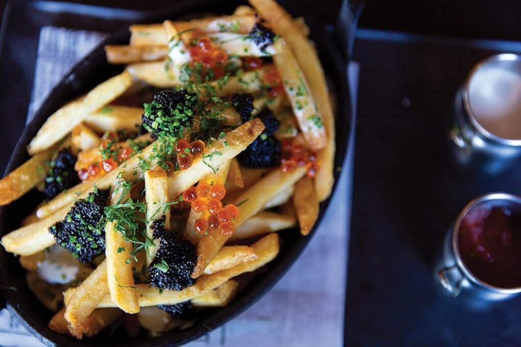 Crisp Yukon fries, Petrossian caviar, salmon roe, citrus crème fraîche, and nine-spice ranch