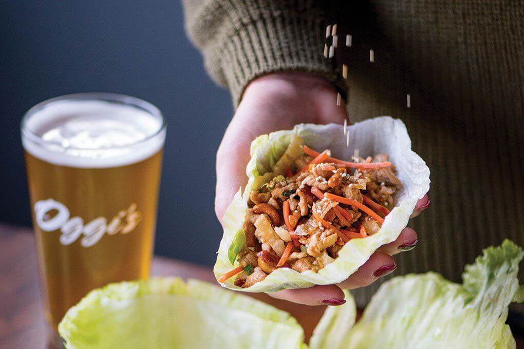 Chicken Lettuce wraps with sesame-soy chicken, carrot, green onion, cashews, five-spice wonton strips, iceberg lettuce