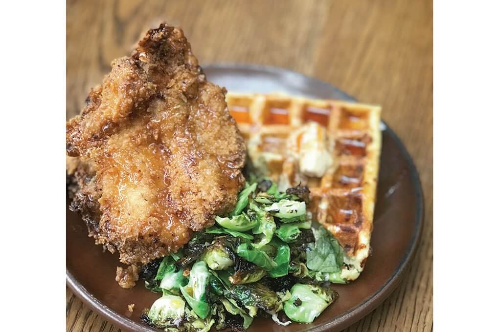 Fried Chicken with a Serrano-pecorino waffle, miso butter, Brussels sprouts, bagna càuda and Sriracha honey