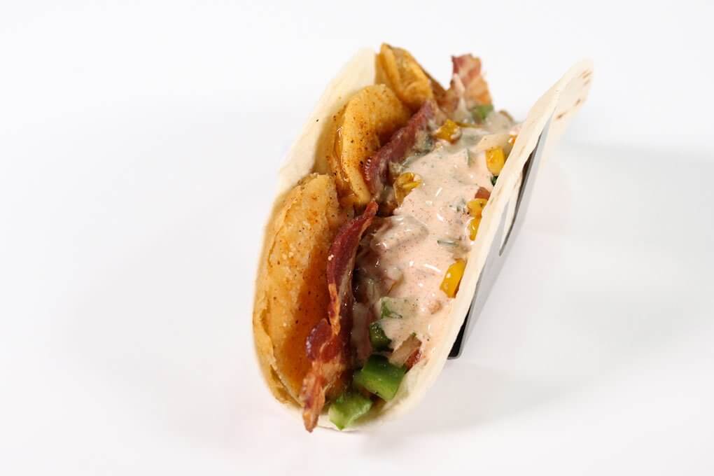 Fried Green Tomato Taco with bacon, Cajun ranch, lettuce, pico de gallo, roasted corn