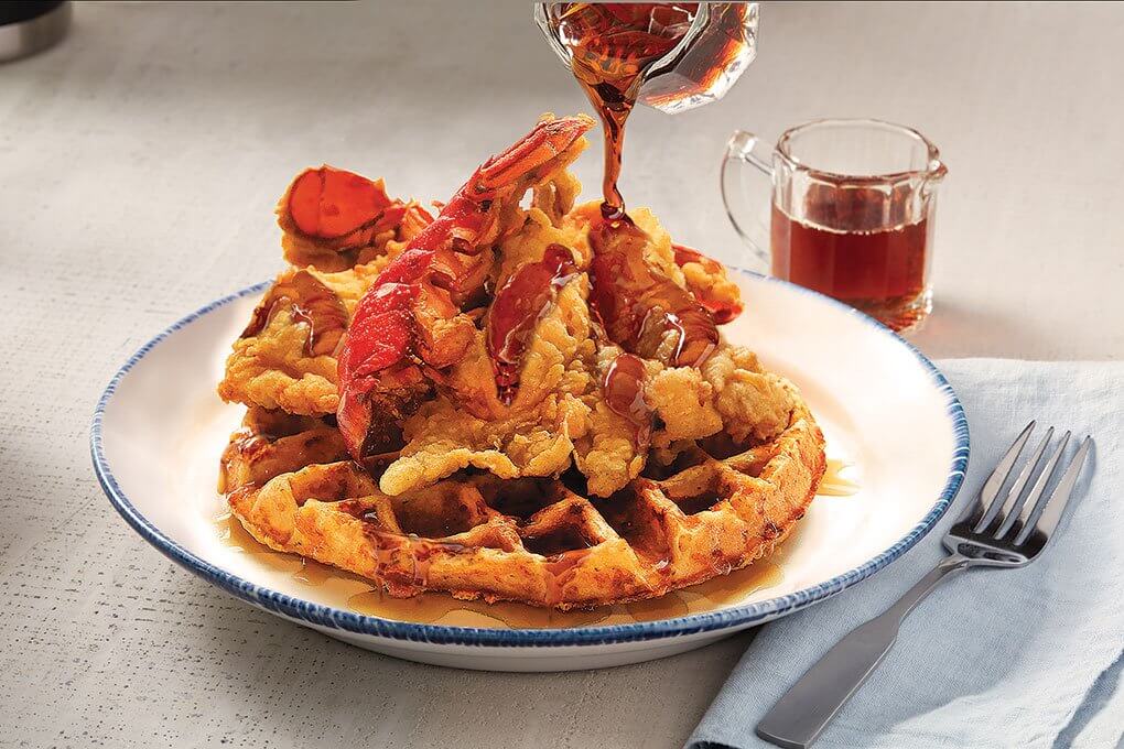 Fried lobster tail over Cheddar Bay Biscuit waffles and maple syrup