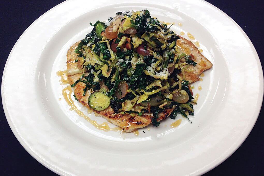 Pan-Seared Chicken Paillard with Lacinato kale, Brussels sprouts, pickled grapes, almonds, orange, Parmesan, honey gastrique