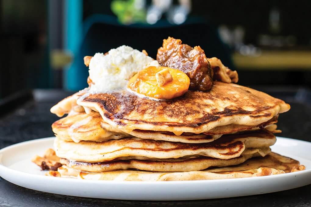 Plátano Maduro Pancakes with banana-passionfruit jam, whipped cream and vanilla-bean maple syrup 