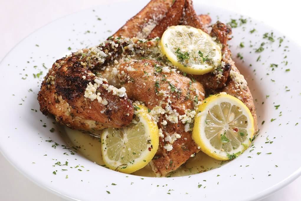 Half chicken, oregano, lemon juice, Parmesan, with roasted russet potatoes