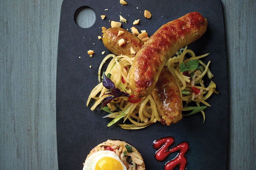 Thai Sausage with fried rice, sunny-side quail’s egg, pickled green papaya