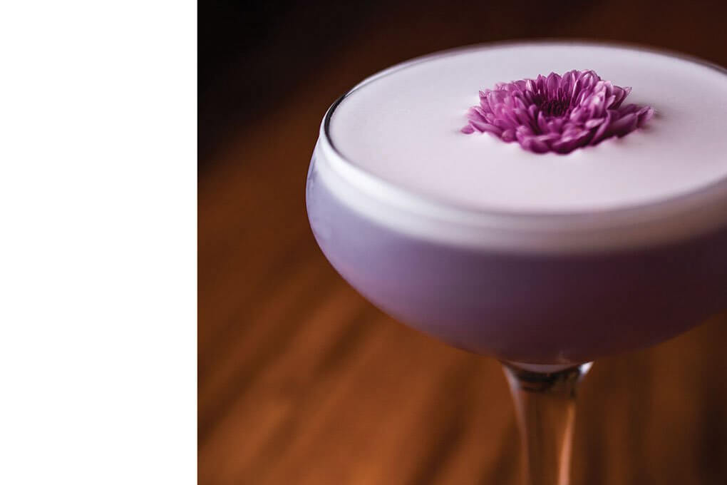 Empress Indigo Gin, lime juice, rosemary syrup, egg white, wildflowers