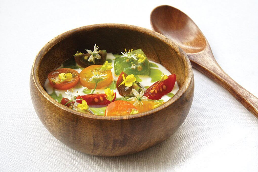 Tomato water-yuzu gelée, tomatoes, house-cultured cream, pistachio oil, allium flowers