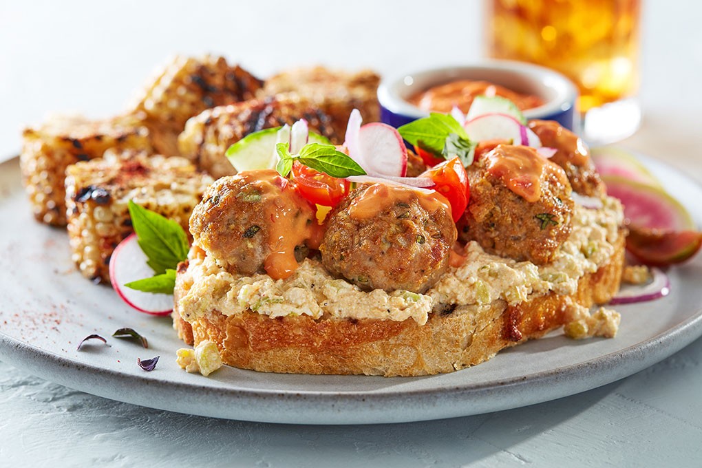 A Curry Cucumber Farmer’s Cheese Spread—with California farmer’s cheese, Madras curry powder, red Thai curry paste, Thai basil leaves, cucumber and shallot—serves as a creamy contrast for turkey meatballs topped with a harissa aïoli.