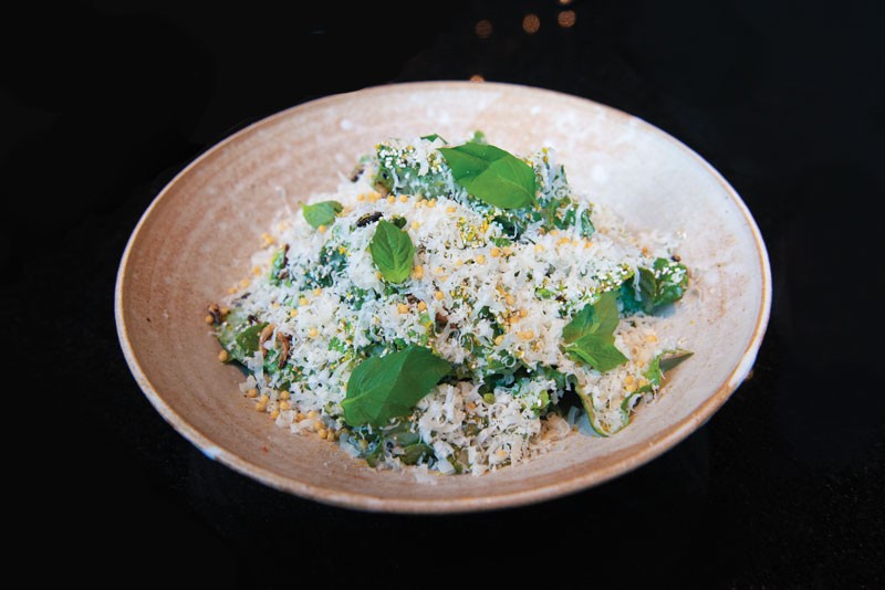 Entente garnishes its Little Gem salad with shaved bottarga, Bosc pear, Parmigiano-Reggiano, torn basil and a sprinkle of golden bubu arare.