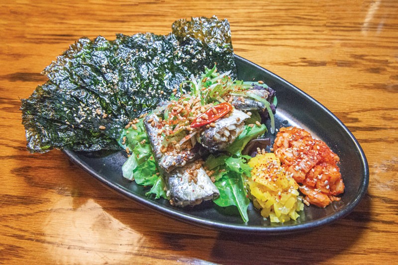 Sardines Conserva at Perilla features mixed greens, toasted nori sheets, toasted rice, kimchi and yellow daikon.