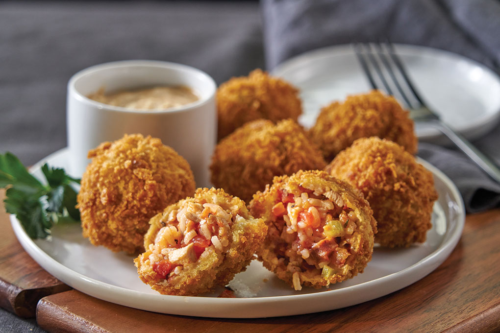 Jambalaya Arancini captures Cajun flavors in a craveable Italian-style bite, featuring U.S.-grown long-grain white rice, chicken and andouille, served with rémoulade. The rice holds the heat well for takeout and carries bold flavors beautifully.