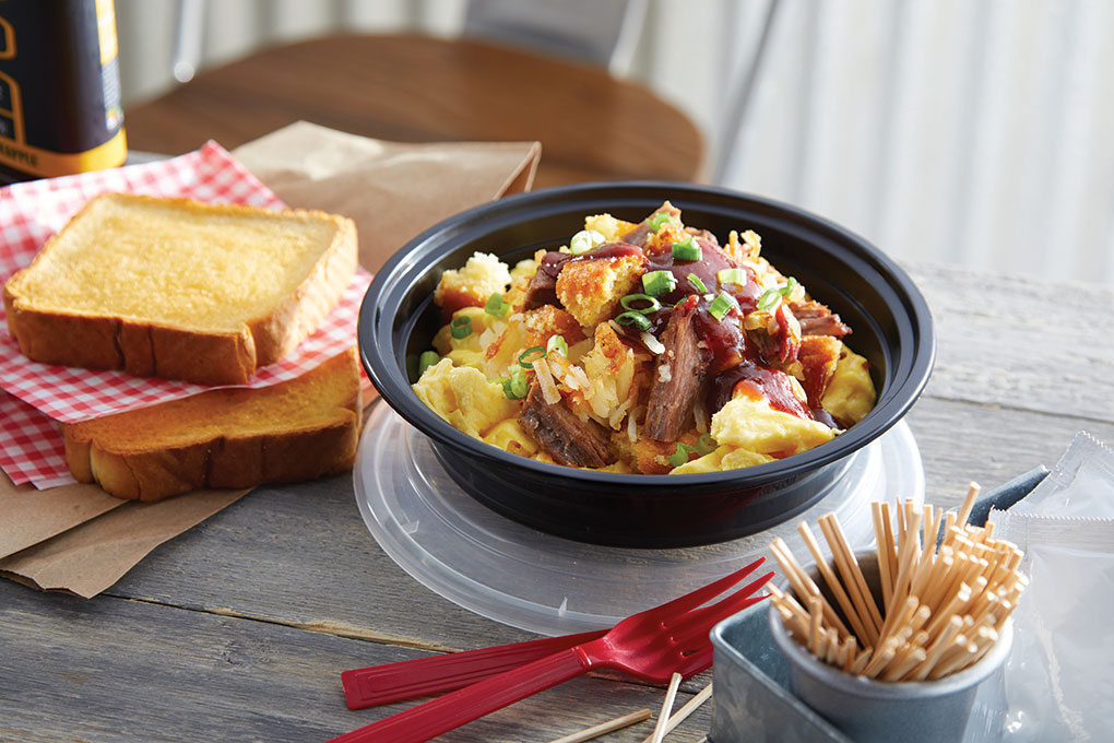 Potato hash is an ideal to-go carrier, retaining heat and texture well. Inspired by Texas Hill Country cuisine, this Country Skillet Hash Bowl combines hashbrown potatoes, buttermilk cornbread crumbles, brisket, onion and soft-scrambled eggs. It’s finished with a sprinkling of green onion and a barbecue sauce drizzle.