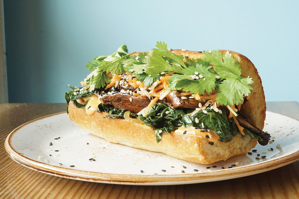 Stacked Sandwich Shop borrows the popular banh mi flavor profile and spins it into a Portobello Banh Mi with sautéed kale, pickled carrot, daikon radish and cilantro, served in a toasted hoagie.