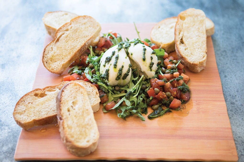 Fare Well in Washington, D.C., menus a vegan burrata “cheese” made with cashew milk, almonds, lactic acid and the magic of time. It’s paired with pesto, balsamic-marinated tomatoes, capers, arugula and a toasted baguette.