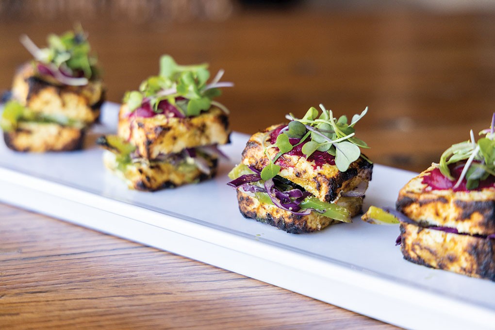 Paneer acts as a crispy, flavorful carrier in this Kaffir Lime Paneer Tikka at Urban Village in Lone Tree, Colo. The cheese is first marinated in kaffir lime, yogurt and spices, then char-grilled and split into a slider, filled with apple, fresh ginger and a mint-cilantro purée.