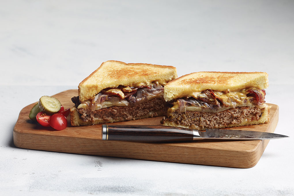 Turkey Patty Melt with honey-bourbon bacon, beer-basted onions and Meunster cheese