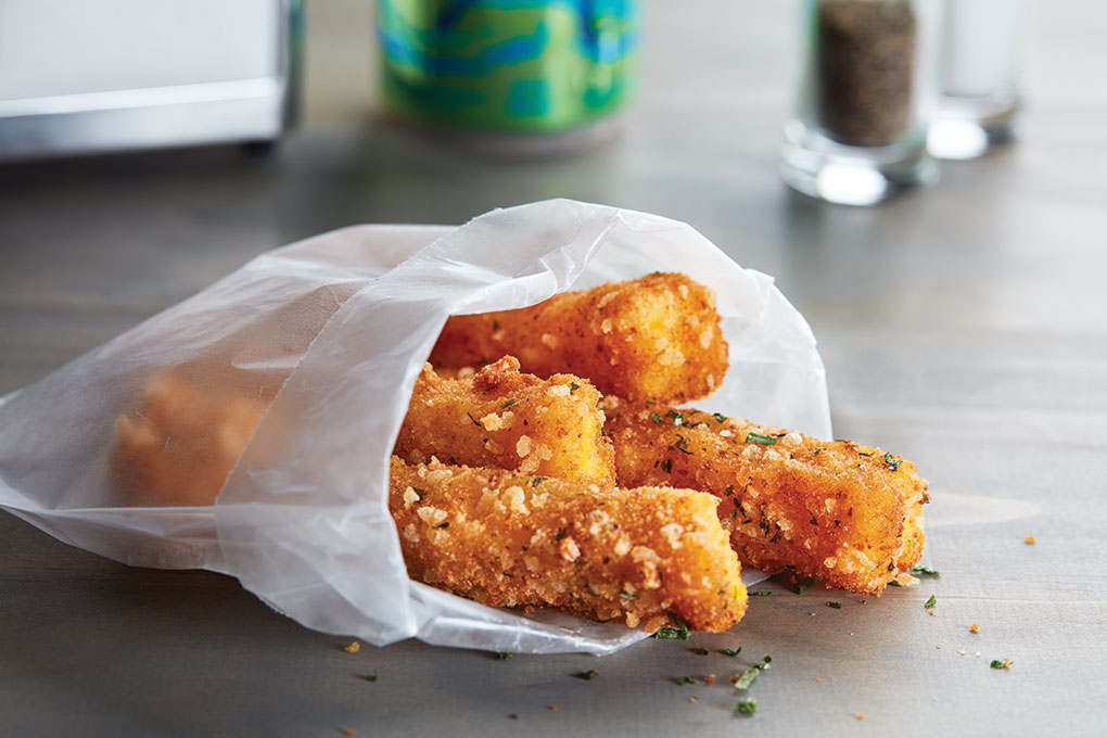 Houlihan’s Michael Slavin calls on pimento cheese to act as the melty component in these crispy panko-breaded Polenta Frites, dusted with Parmesan and parsley.