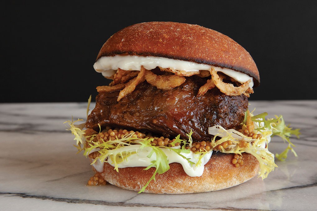 Attention to culinary detail is on full display at food truck Layers Sandwich Co. in Seattle. The Deja Moo stars braised short rib, pickled mustard seeds, crispy onions, frisée and housemade aïoli on a toasted potato bun.