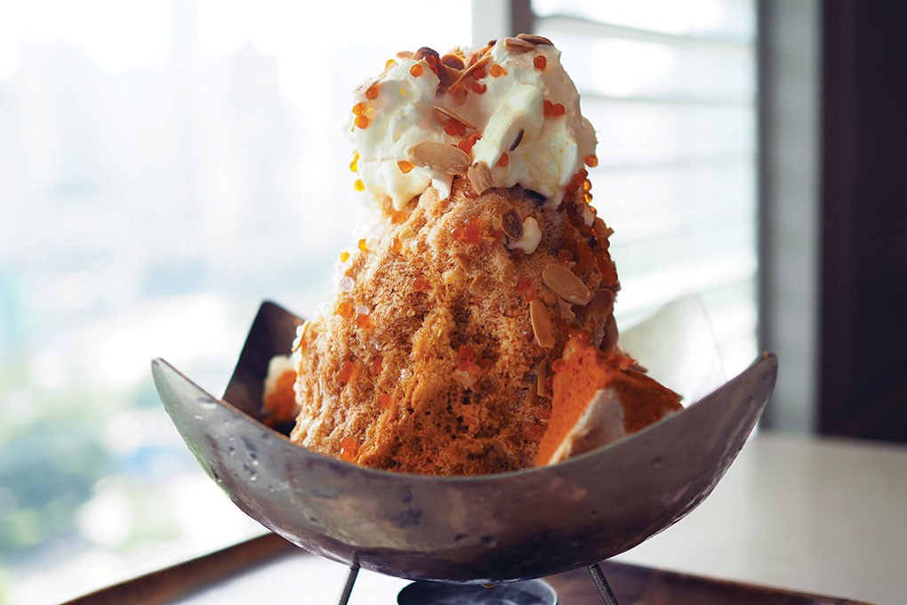 The flavors of Thai tea get transformed into a showstopping Thai Tea Shaved Ice, served with a scattering of tamarind boba and toasted almonds over whipped cream.