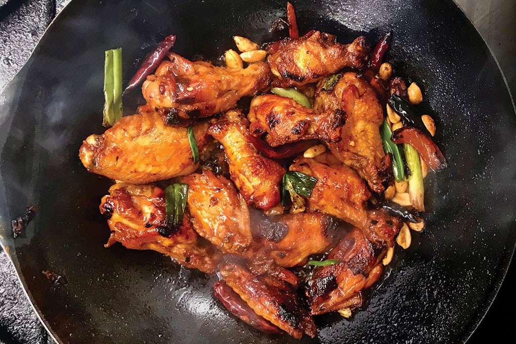 Kung Pao Wings on the secret menu of Denver food truck Yuan Wonton pull in flavor from a soy-ginger glaze, hot chiles and crunchy peanuts.