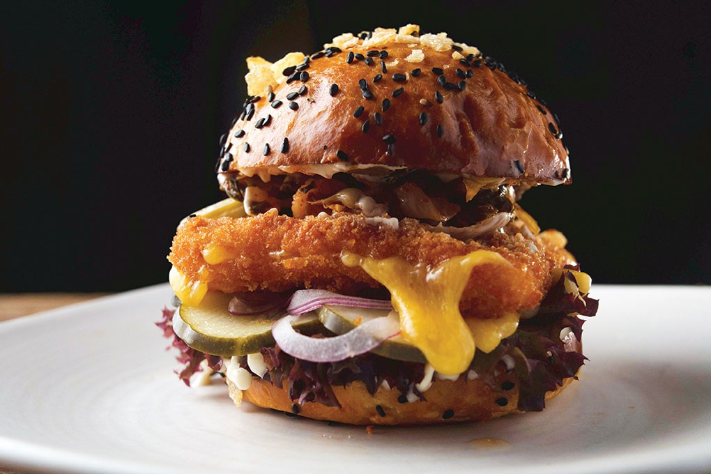 San Francisco’s Curio Bar & Restaurant serves its inventive, indulgent Curio Katsu Cheddar Sandwich with miso mayo, lettuce, red onion and kimchi on a toasted potato chip-sesame bun.