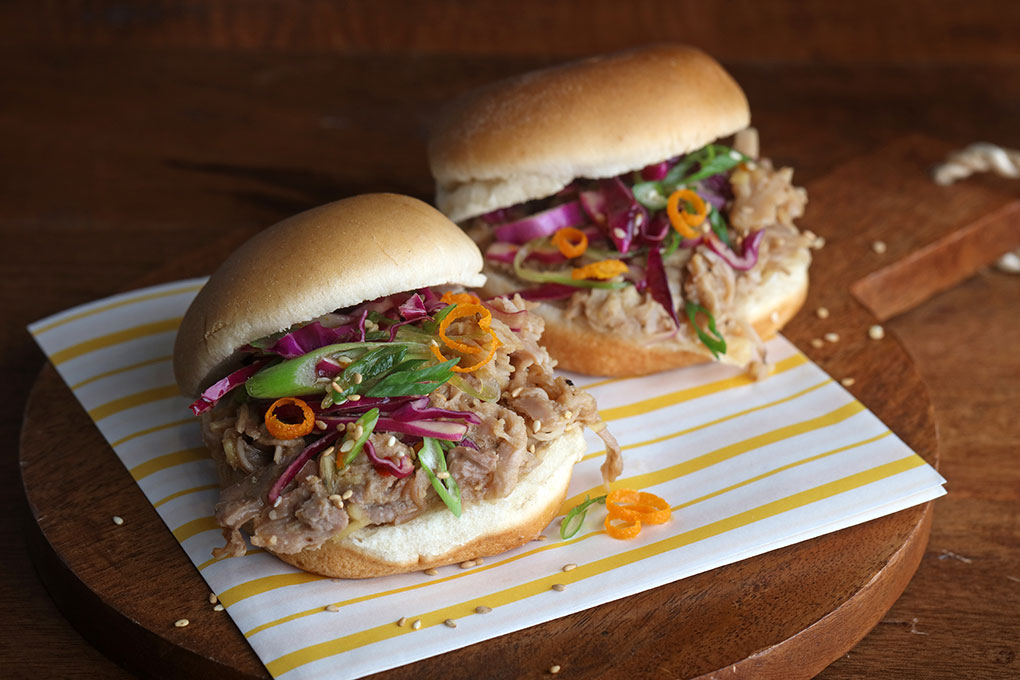 Orange Pepper Pulled Pork Sliders celebrate the craveable flavors of the classic orange sauce, making a bright-hot version and featuring it on these Orange Pepper Pulled Pork Sliders. A crisp and colorful Greens Slaw adds crunch.