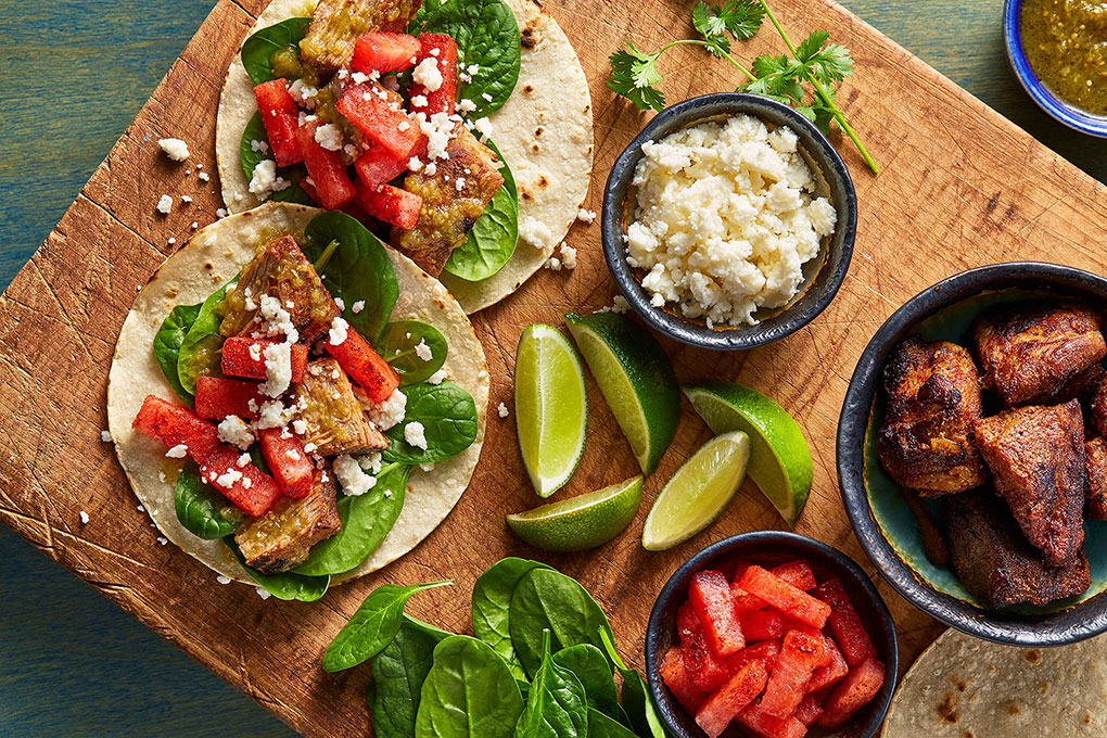 In Chef Jay Smith’s recipe, chile-rubbed compressed watermelon and slow-cooked carnitas paired with spinach, salsa verde, queso fresco and cilantro in a fresh grilled corn tortilla.
