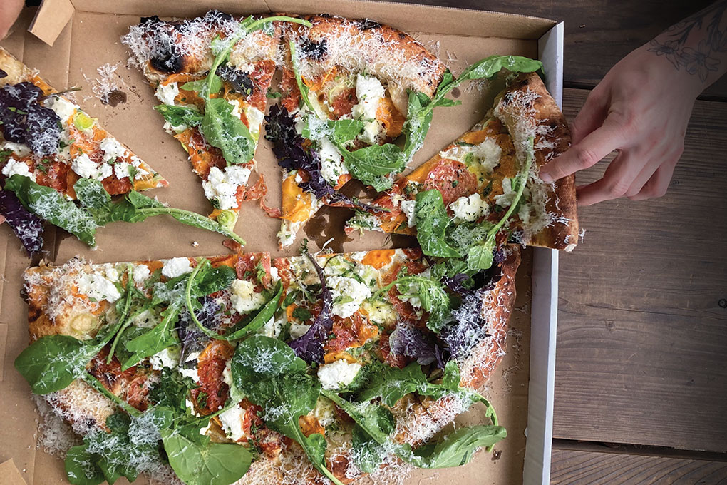 Seasonal pies feature eclectic flavor combos at June’s Pizza, like persimmons and greens.