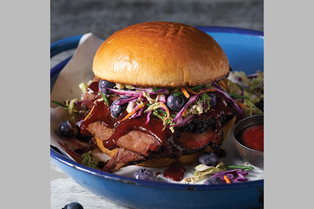 Savory and sweet make a craveable flavor combination in this Texas Blueberry Brisket Sandwich. Served on a brioche bun, tender brisket rubbed with blueberry powder is smoked and glazed with a sweet-smoky Texas Blueberry Barbecue Sauce. It’s then topped with a crisp carrot and red cabbage slaw studded with blueberries.