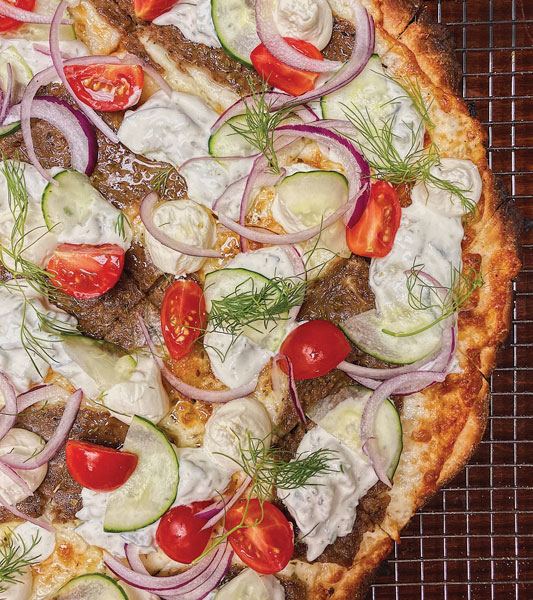 Professor Pizza, a virtual kitchen in Chicago, offers unique flavor profiles like this Gyro Pizza with a cracker-thin crust, gyro meat, tzatziki sauce, whipped feta, cucumber, tomato, red onion and dill.