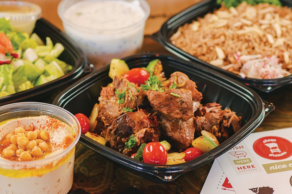 Lebanese Taverna, based in Washington, D.C., packages the components of this Lamb Family Meal separately. The braised lamb and spiced rice are served with hummus, bread and a yogurt salad.