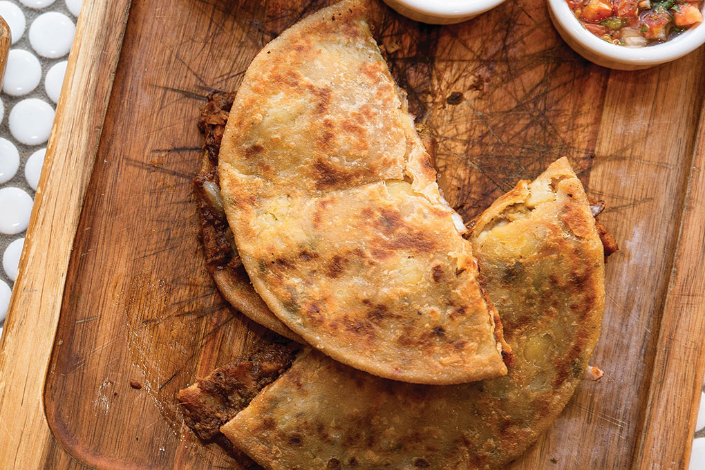Fast casual Curry Up Now offers an Indian spin with its Quesadillix, a paratha stuffed with potato, mozzarella and a choice of protein, served with pickles, chaat masala yogurt and chutney.