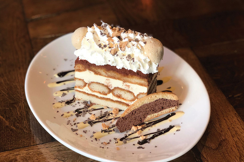 The tiramisu at Siena Tavern in Chicago layers roasted white chocolate into mascarpone for texture, and drizzles it over top as a signature flourish.