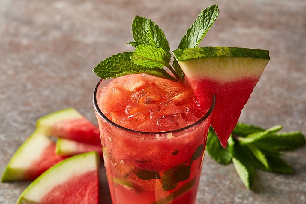 This cocktail is a fun play on a traditional mojito, infused with watermelon simple syrup and the smokiness of mezcal.