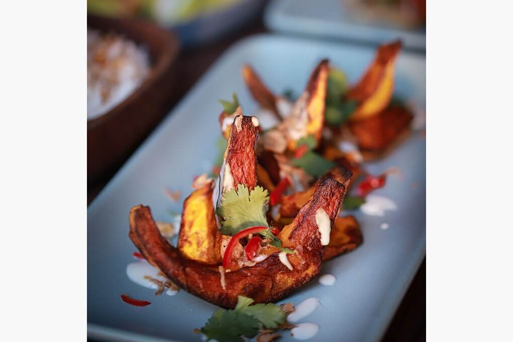 Roasted Kabocha Squash with coconut milk glaze, fried shallots and garlic, fresh cilantro and slices of Fresno chile