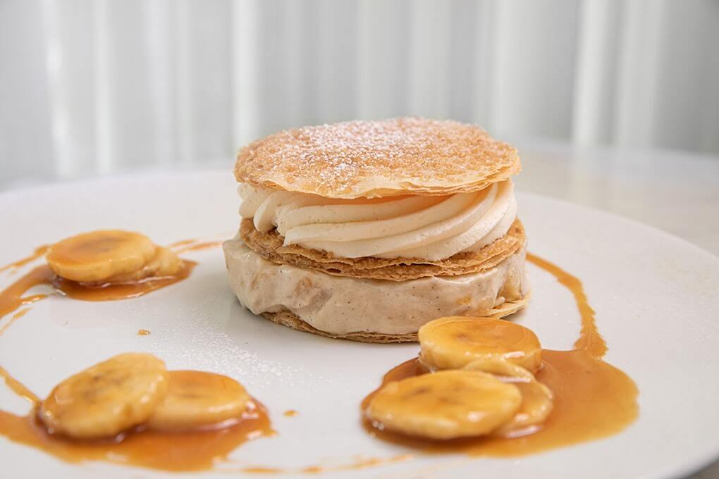 Banana Cream Napoleon with warm caramel, phyllo, banana filling and vanilla whipped cream