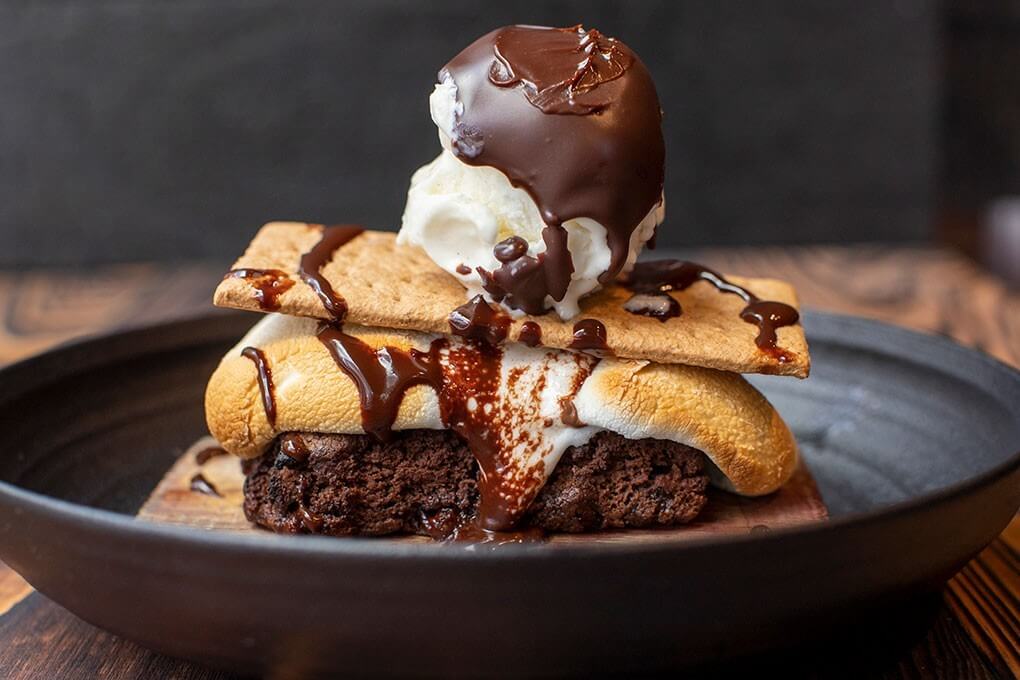 Cedar plank-smoked brownie, milk chocolate bar, marshmallows, graham cracker, Grand Marnier-infused chocolate ganache and vanilla bean ice cream