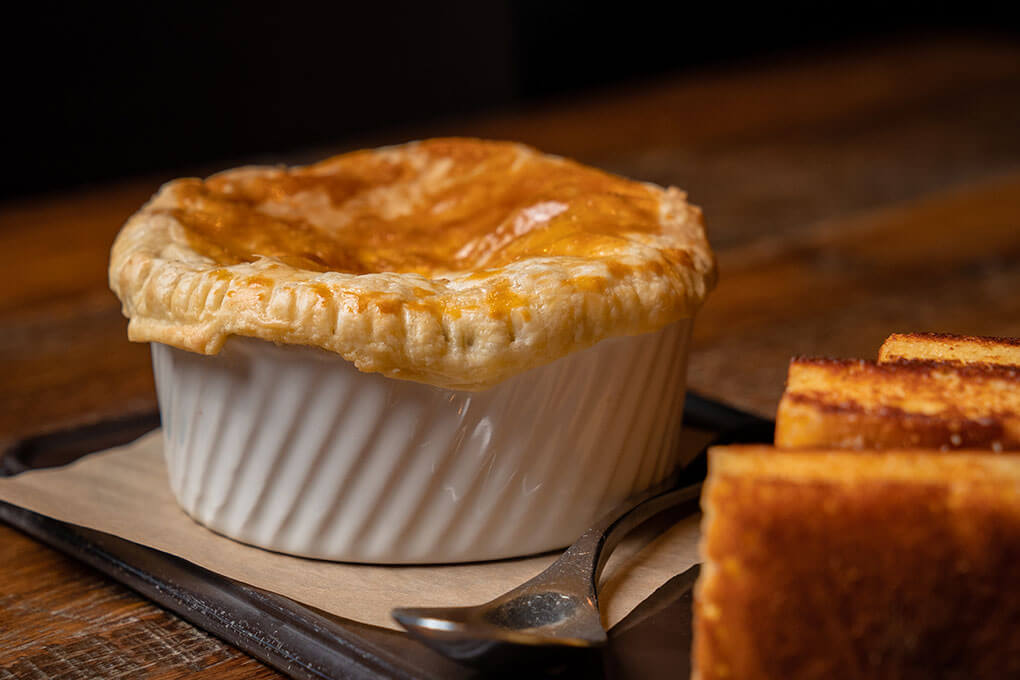 Flaky crust filled with crawfish, seasonal vegetables, creamy dill sauce and Cajun seasonings, served with cornbread