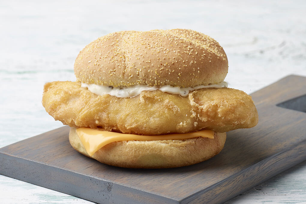 Natural-cut cod fillet in Yuengling beer-infused batter, with American cheese and tartar sauce on a corn-dusted kaiser roll
