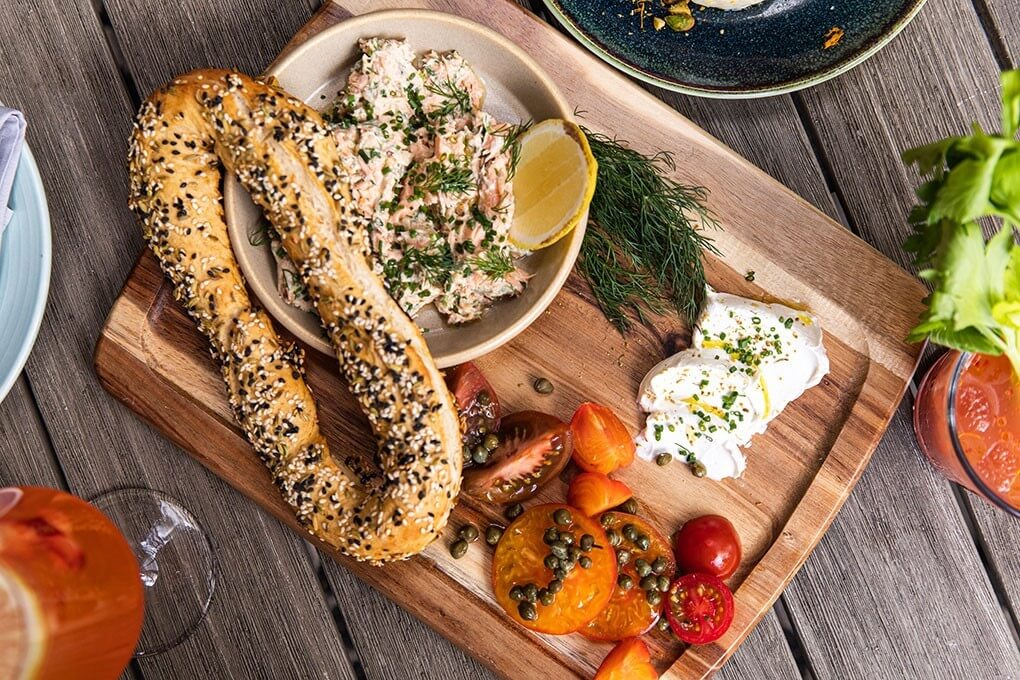 Jerusalem Bagel with smoked salmon spread, tomatoes, capers and labneh