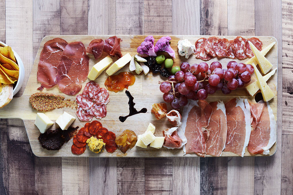 Rotating selection of cured meats and cheeses served with fresh honeycomb, blood orange mostarda, crabapple and micro vegetables