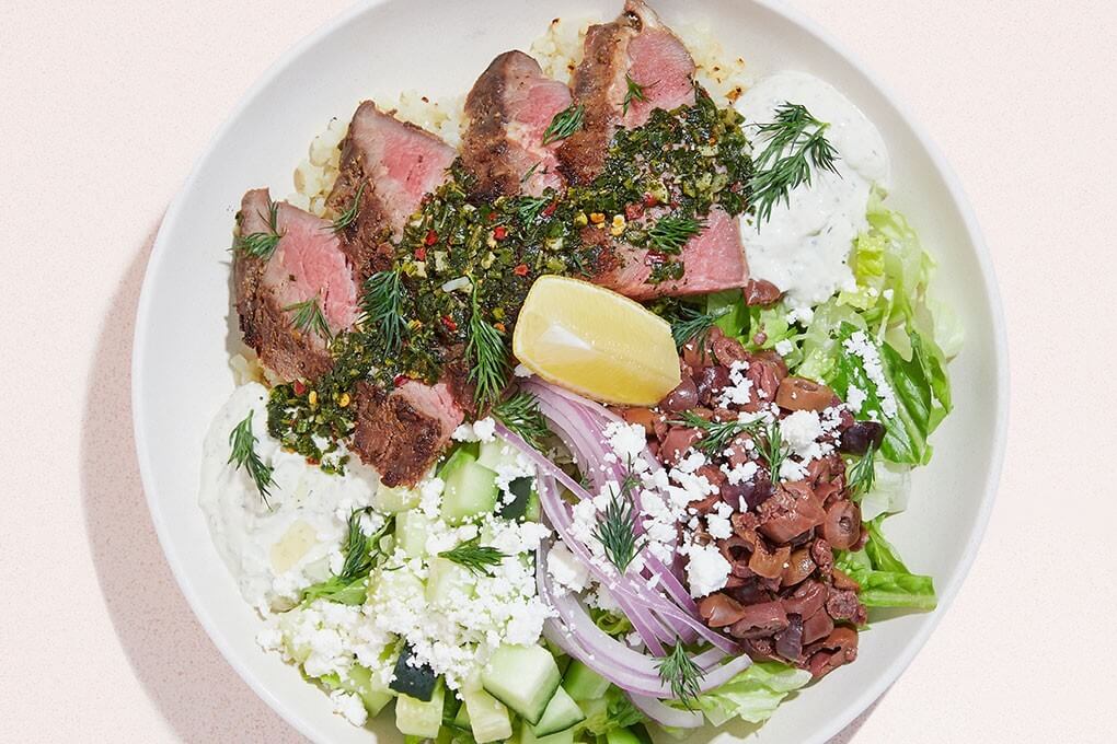 Grass-fed flank steak, cauliflower rice, chimichurri, red onion, cucumber, Kalamata olives, romaine and feta with a tahini and herb-yogurt sauce