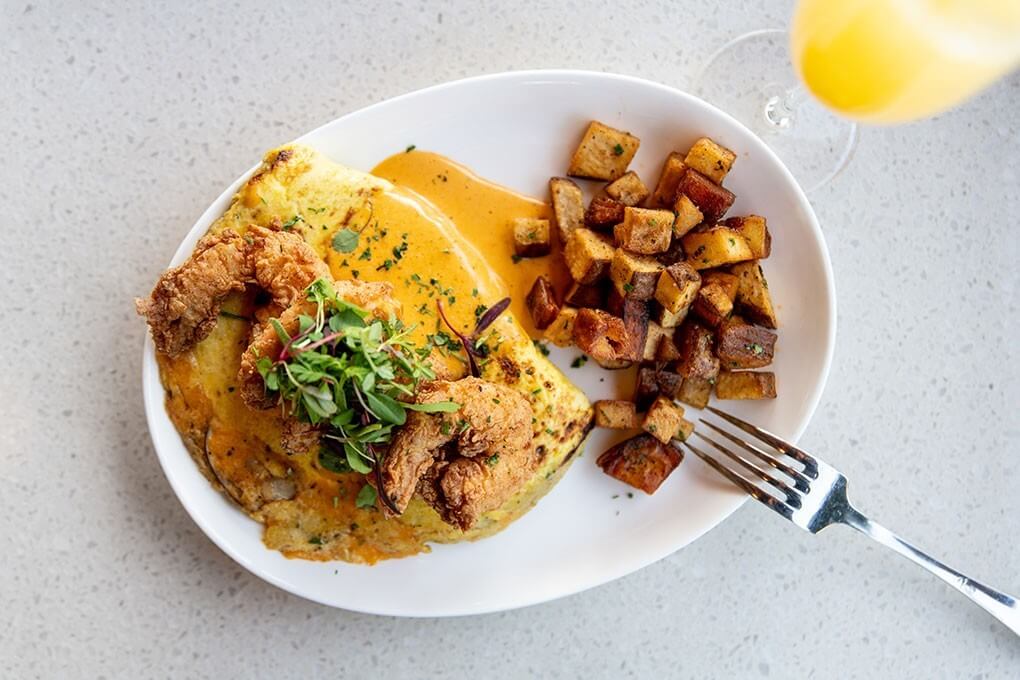 Three-egg omelette, mushrooms, cheddar, fried shrimp and Cajun hollandaise, served with Brabant potatoes