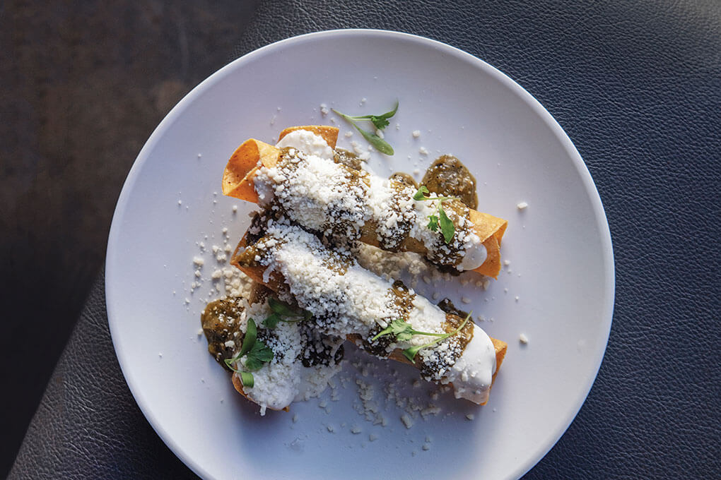 Pibil Chicken Taquitos with housemade garlic ranch, salsa verde and Cotija cheese