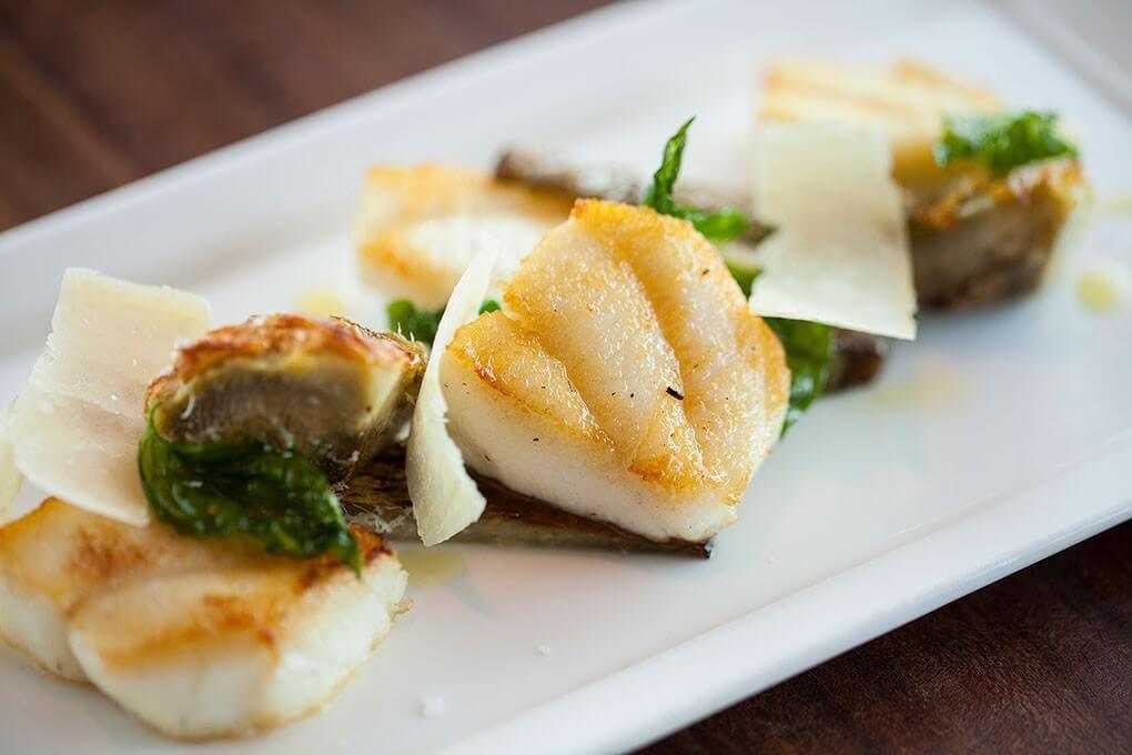 Pan Roasted Halibut Cheeks with artichoke hearts and Parmigiano-Reggiano