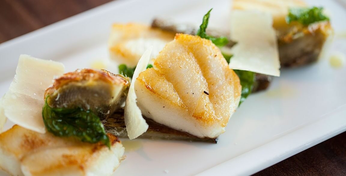 Pan Roasted Halibut Cheeks with artichoke hearts and Parmigiano-Reggiano