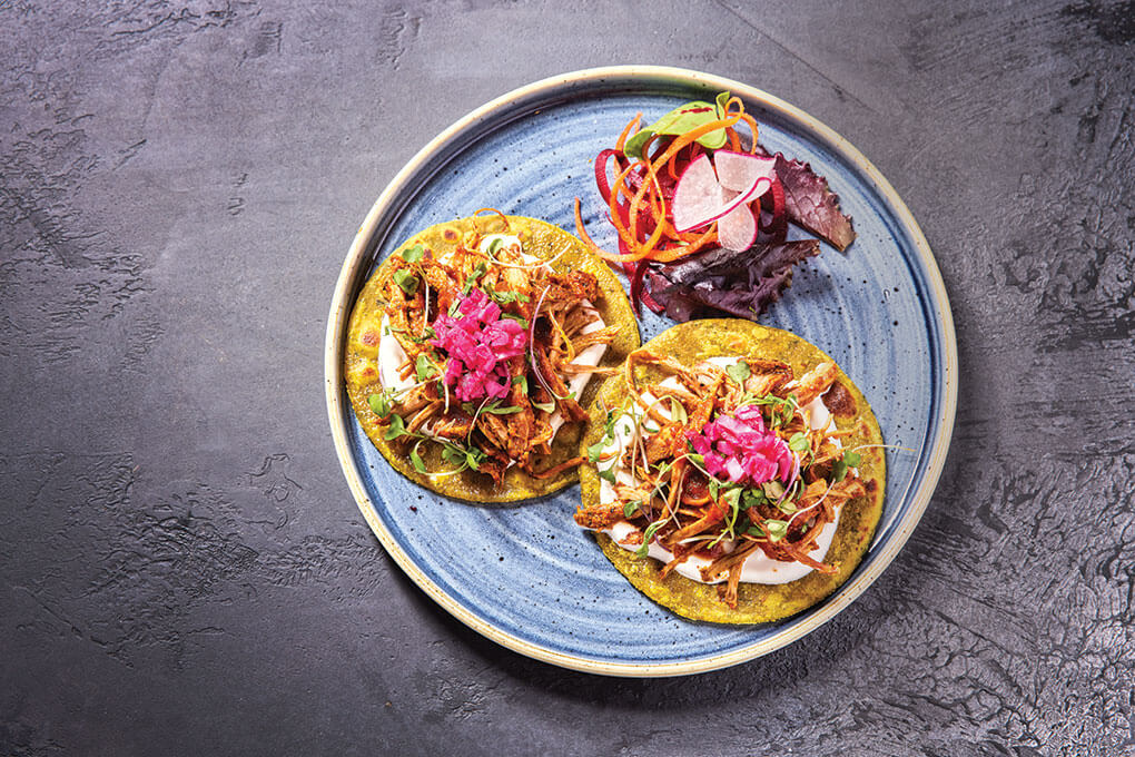 Pulled Pork Thepla Tacos with sour cream, micro greens and pickled red onions