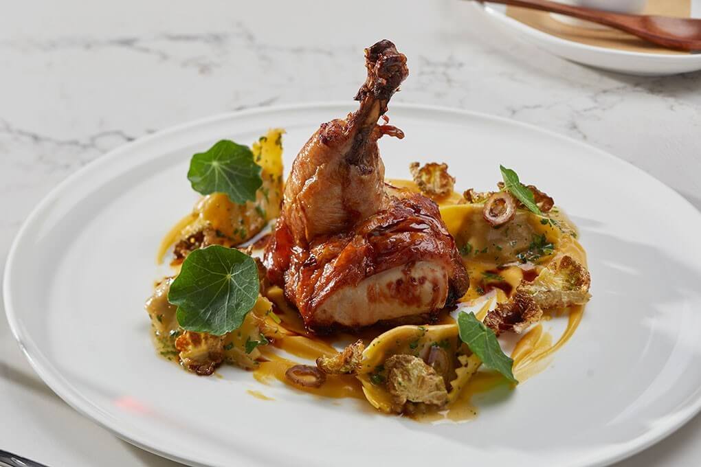 Roasted chicken with sweet corn soubise, Ozark Forest mushrooms, Boursin agnolotti and dark poultry jus